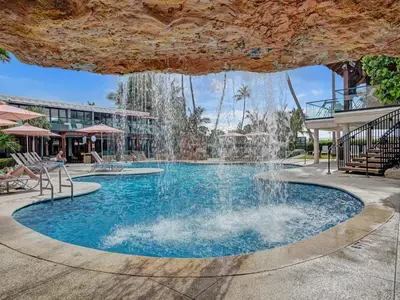 a pool with a waterfall in a resort at Luxury Penthouse 3BR 3BA Oceanfront PH7 in Miami Beach