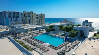 an aerial view of a resort with a swimming pool and the ocean at Nido del amor in Hollywood