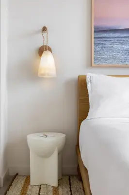 a bedroom with a white bed and a lamp at Flow Hotel Miami in Miami
