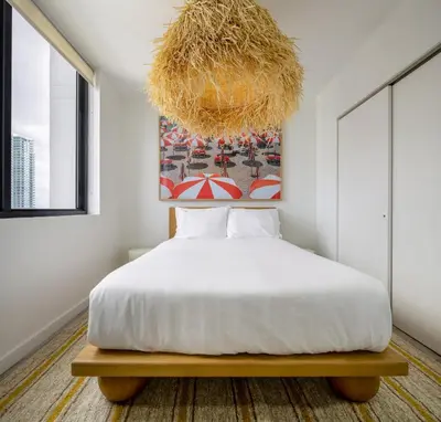 a bedroom with a bed and a chandelier at Flow Hotel Miami in Miami