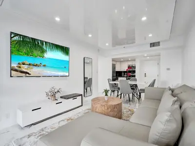 a white living room with a couch and a table at High Floor Miami Beach Pool Beach Service 1219 in Miami Beach