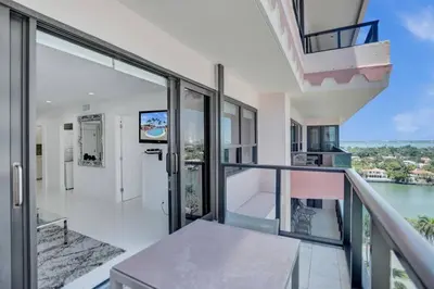 a balcony with glass doors and a view of the water at High floor 2BD with beach service 1616 in Miami Beach