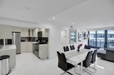 a kitchen and dining room with a table and chairs at High floor 2BD with beach service 1616 in Miami Beach