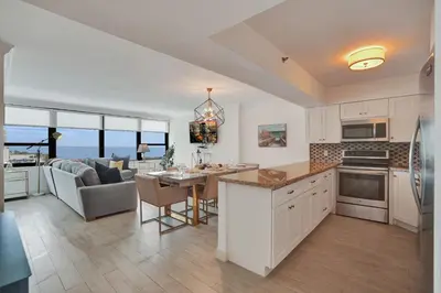 a kitchen and living room with a view of the ocean at Adorable 2 Bedroom Condo Beach Service 904 in Miami Beach