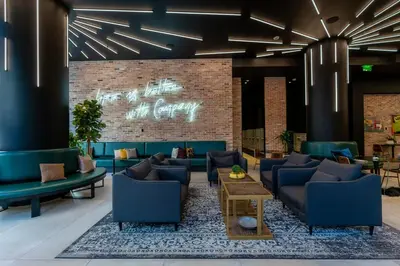 a lobby with blue furniture and a brick wall at The Bayfront II in Miami