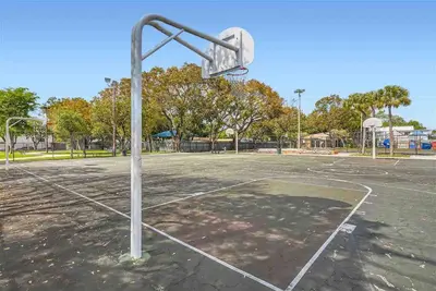 an old basketball hoop on a basketball court at Modern Miami House 2Baths Design District in Mins in Miami