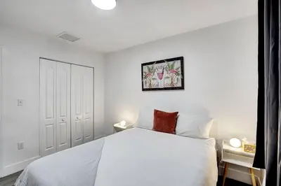 a white bedroom with a white bed and a white wall at Modern Miami House 2Baths Design District in Mins in Miami