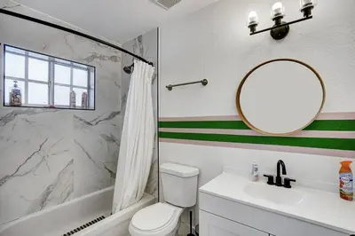 a bathroom with a sink toilet and a mirror at Modern Miami House 2Baths Design District in Mins in Miami