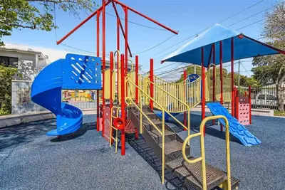 a playground with blue and red playground equipment at Modern Miami House 2Baths Design District in Mins in Miami