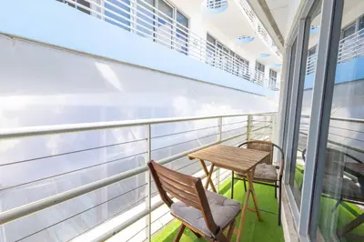 a balcony with a table and chairs on a cruise ship at King 1 Bed Apt with rooftop pool C202 in Miami Beach