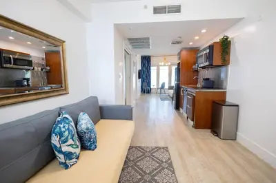 a living room with a couch and a kitchen at King 1 Bed Apt with rooftop pool C202 in Miami Beach