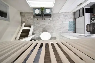 a room with a bed in the middle of it at Modern Loft wsteps to Beach Kitchenette in Hollywood
