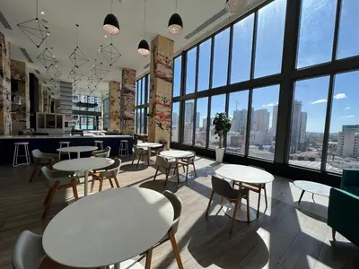 a restaurant with tables and chairs and large windows at Apartment in Miami downtown in Miami