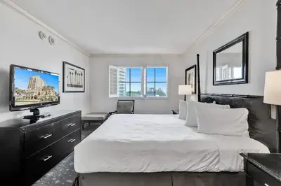 a bedroom with a large white bed and a flat screen tv at Private Residences at The Atlantic Resort & Spa in Fort Lauderdale