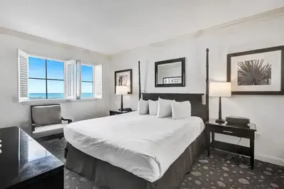 a hotel room with a large bed and two windows at Private Residences at The Atlantic Resort & Spa in Fort Lauderdale