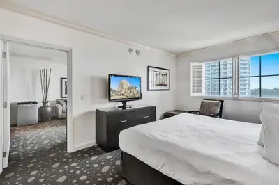 a white bedroom with a large bed and a television at Private Residences at The Atlantic Resort & Spa in Fort Lauderdale