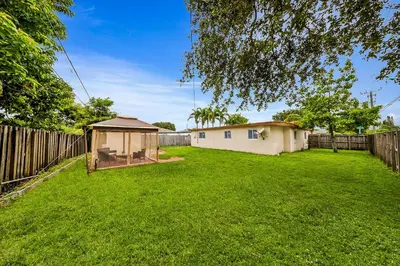 a backyard with a gazebo and a fence at Casa Neisy Florida 10 minutes from Hollywood Beach and Hard Rock Hotel & Casino Hollywood in Hollywood