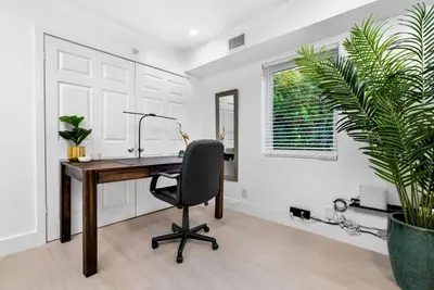 an office with a desk and a chair and a plant at The Riverside Retreat 1 in Fort Lauderdale