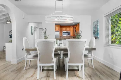 a dining room with a table and chairs at The Riverside Retreat 2 in Fort Lauderdale