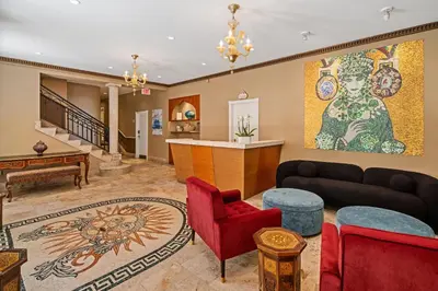 a living room filled with furniture and a painting on the wall at Kasa La Flora And Impala Miami Beach in Miami Beach