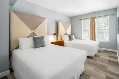 a bedroom with two beds and a window at Kasa La Flora And Impala Miami Beach in Miami Beach