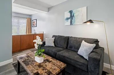 a living room with a couch and a table at Kasa La Flora And Impala Miami Beach in Miami Beach