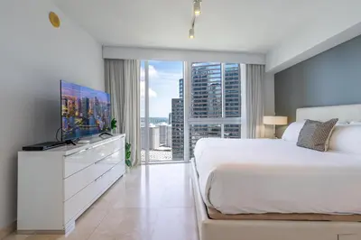 a bedroom with a large bed and a large window at ICON Brickell Miami- 2 bedroom Condo with City and water views! in Miami