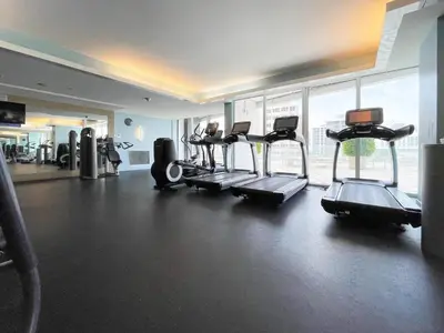 a gym with several treadmills and a large window at 2BR Fort Lauderdale W Residence with Double Living Room, Ocean & Intercoastal Views, Brand New Sofas! in Fort Lauderdale