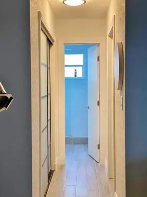 a hallway with a blue door and a tile floor at Block from Beach one bedroom with Parking in Miami Beach