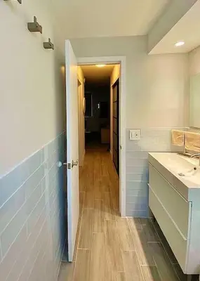 a bathroom with a sink and a hallway at Block from Beach one bedroom with Parking in Miami Beach