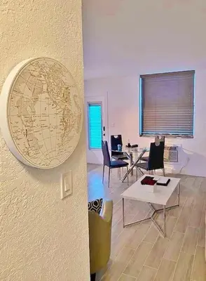 a living room with a world map on the wall at Block from Beach one bedroom with Parking in Miami Beach