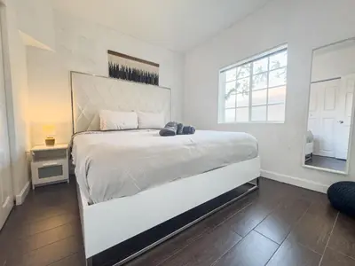 a white bedroom with a large white bed in it at Dos Casitas Design District #1 - 3 Bedroom House in Miami