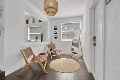 a living room with two chairs and a table at Dos Casitas Design District #1 - 3 Bedroom House in Miami