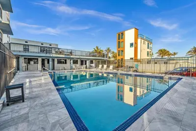 a swimming pool in front of a building at Beachfront & Pool Near Marriott Hollywood Beach in Hollywood