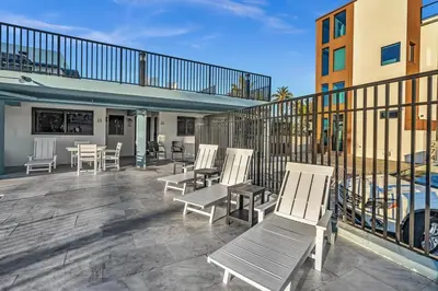 a patio with chairs and tables and a pool at Beachfront & Pool Near Marriott Hollywood Beach in Hollywood