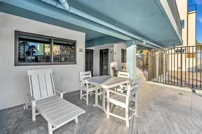 a patio with a table and chairs on a balcony at Beachfront & Pool Access Unit W 2 Queen Beds in Hollywood