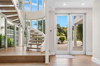 a white staircase in a house with glass doors at Villa Seminole in Fort Lauderdale