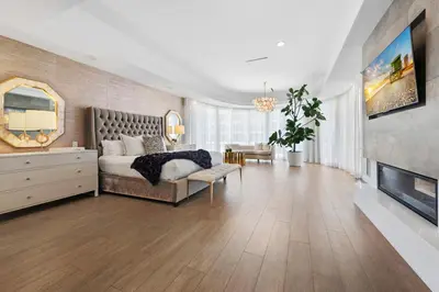 a large bedroom with a bed and a fireplace at Villa Seminole in Fort Lauderdale