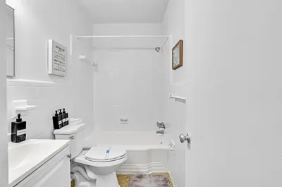 a white bathroom with a toilet and a sink at Studio Retreat With 2 Queen Beds Hollywood Blvd in Hollywood