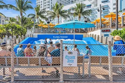 a group of people at the beach behind a fence at Studio Retreat With 2 Queen Beds Hollywood Blvd in Hollywood