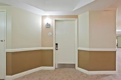 an empty hallway with a white door in a room at Trump International Beach Resort Deluxe 2 Queen Ocean Front in Sunny Isles Beach