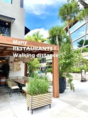 a sign for a restaurant with a table and chairs at GroveO4 10 min from the Beach in Miami