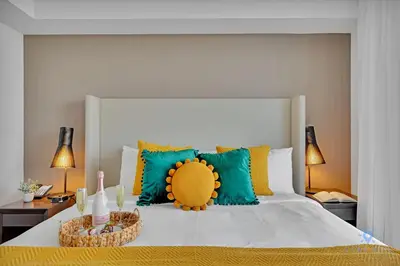 a bedroom with a large bed with colorful pillows at Front Intercostal Luxury Apt View Amazing in Hollywood