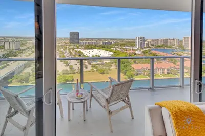 a room with a balcony with a table and chairs at Front Intercostal Luxury Apt View Amazing in Hollywood