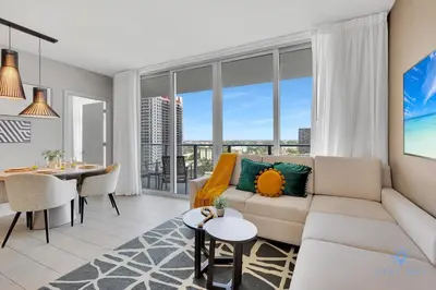 a living room with a couch and a dining room at Front Intercostal Luxury Apt View Amazing in Hollywood