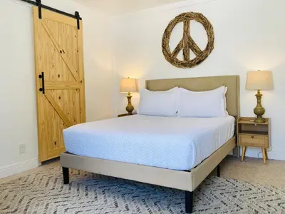 a bedroom with a bed and a door at Wilton Manors Guesthouse in Fort Lauderdale