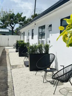 a row of chairs and tables in front of a building at Wilton Manors Guesthouse in Fort Lauderdale