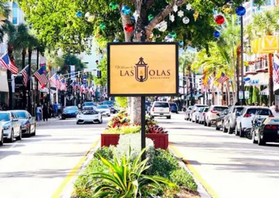 a sign on a street with cars parked at Wilton Manors Guesthouse in Fort Lauderdale