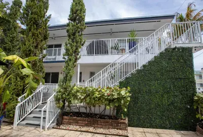 a white staircase in front of a white house at Beachside All Suites Hotel in Miami Beach