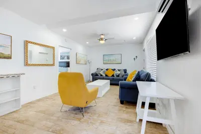 a living room with a couch and a table at ULTRA chic apartment steps from the beach in Hollywood